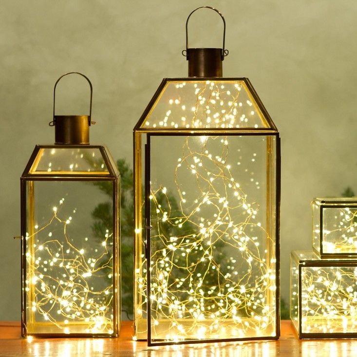 string lights in metal framed glass lanterns